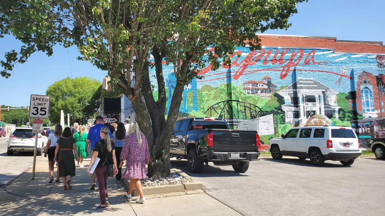 City of Sapulpa Codes and Standards by TSW, Tulsa - 2 story painted mural on a building with people walking along the sidewalk